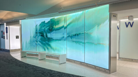 Photo of a green glass wall near the entrance to renovated restrooms in Concourse C at BWI Marshall Airport.