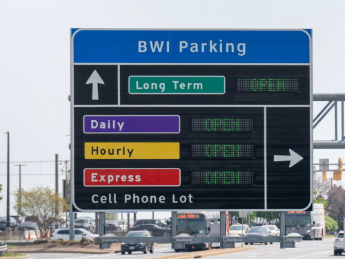 Photo of an overhead roadway sign showing availability of BWI Thurgood Marshall Airport parking facilities.